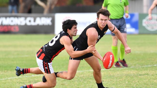 Port District’s Trent Heffernan tries to escape a Rostrevor Old Collegians opponent’s tackle last year. Picture:  AAP/ Keryn Stevens