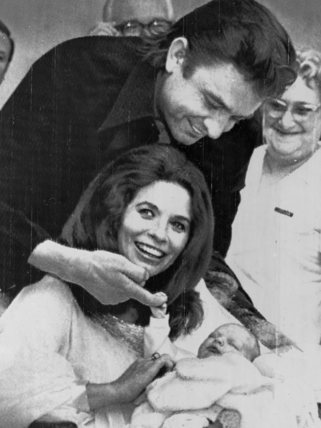 Singer Johnny Cash and his wife June Carter Cash, leave Nashville hospital with their newborn son John, in 1970. Picture: Supplied