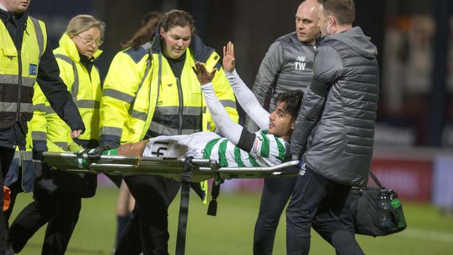 Celtic’s Daniel Arzani is stretchered off after suffering an injury against Dundee. Picture: Jeff Holmes/PA Wire