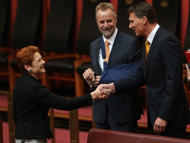 Senator Cory Bernardi shakes hands with Senator Pauline Hanson just before announcing his intention to quit the Liberal Party. Picture: Gary Ramage