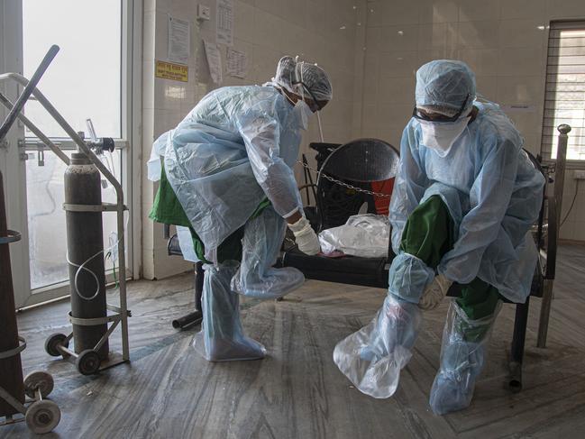 Indian health workers wear personnel protective equipment kit before their shift at a COVID-19 check area in Guwahati Medical College Hospital (GMCH) in Gauhati, India. Picture: AP