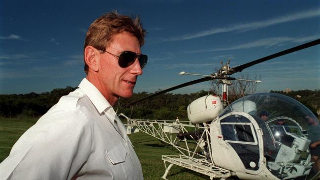 Helicopter pilot Tim Joyce with his helicopter which was hijacked by Lucy Dudko so she could help her lover, John Killick escape from a Sydney jail.