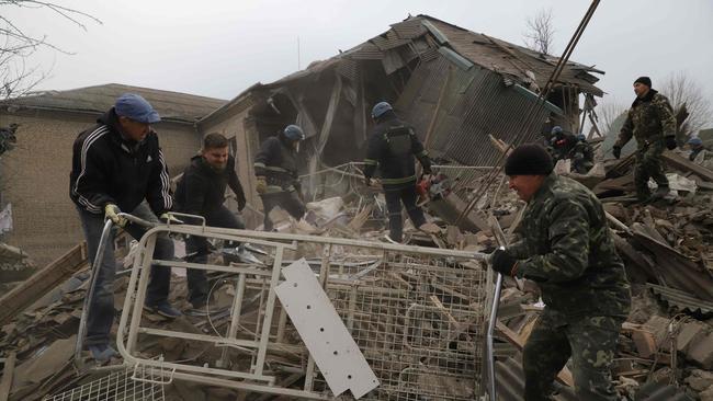 Rescuers clear debris of the destroyed two-storey maternity building in the town of Vilnyansk, southern Zaporizhzhia region.