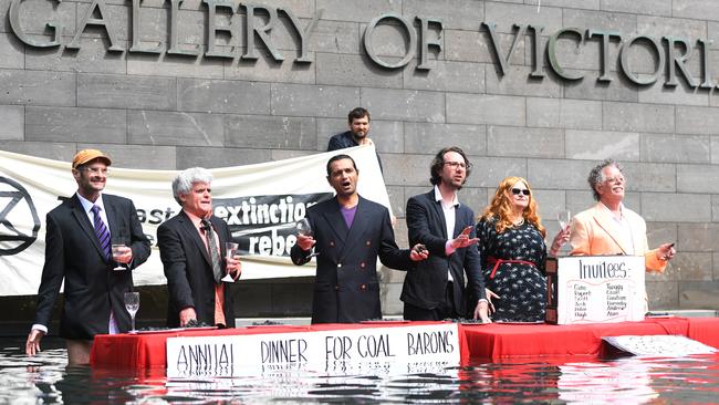 Extinction Rebellion protesters hold 'The Last Supper' in the water outside the National Gallery of Victoria. Picture: Erik Anderson