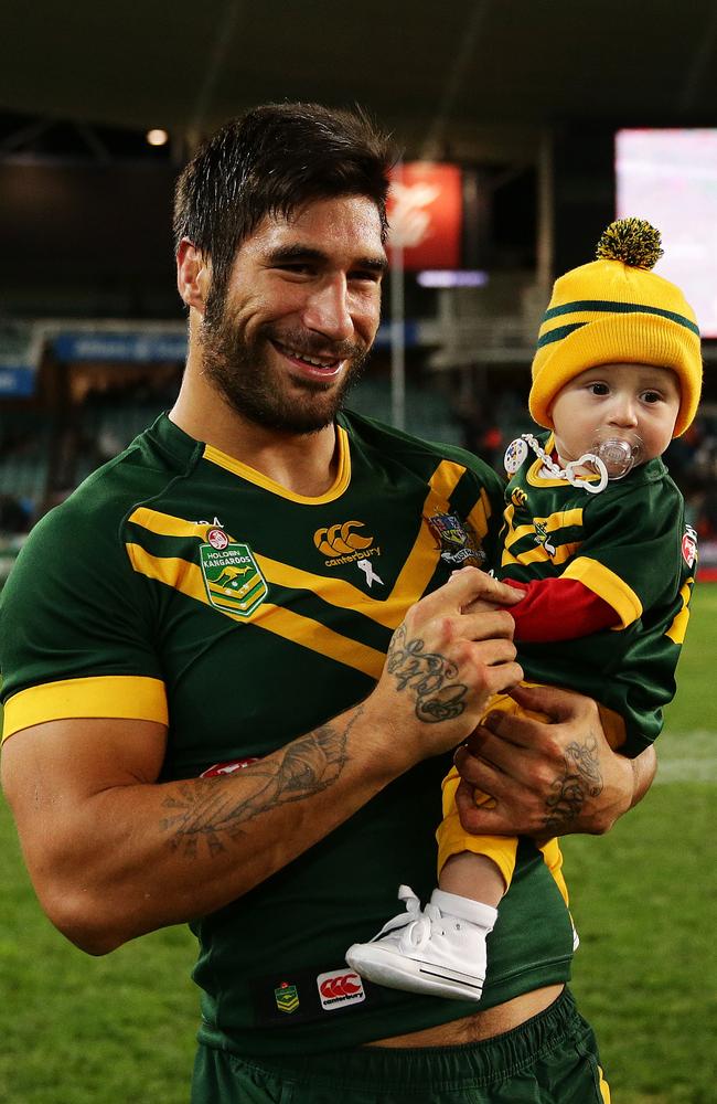 James Tamou celebrates beating the Kiwis in Sydney with son Brooklyn.