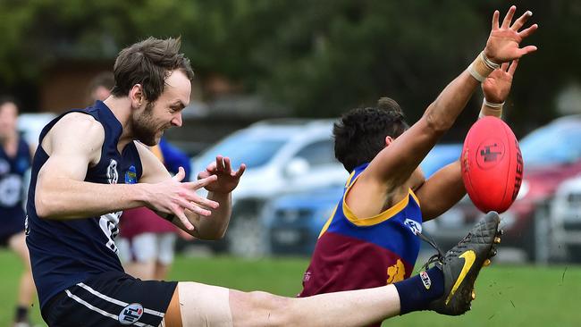 South Morang’s Craig Meredith smothers Bryce Judd’s kick in Epping’s close win over South Morang. Picture: Carmelo Bazzano.