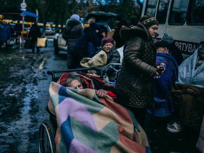 A woman shelters from the biting cold beneath multiple blankets after her escape from Irpin. Picture: Julia Kochetova