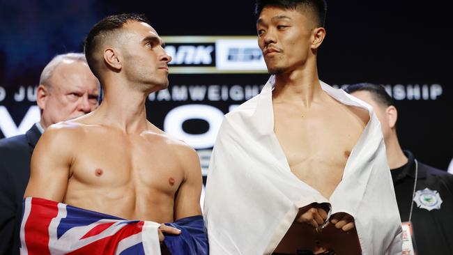 Andrew Moloney of Australia (L) faces off against Junto Nakatani of Japan (R) during a ceremonial weigh-in.