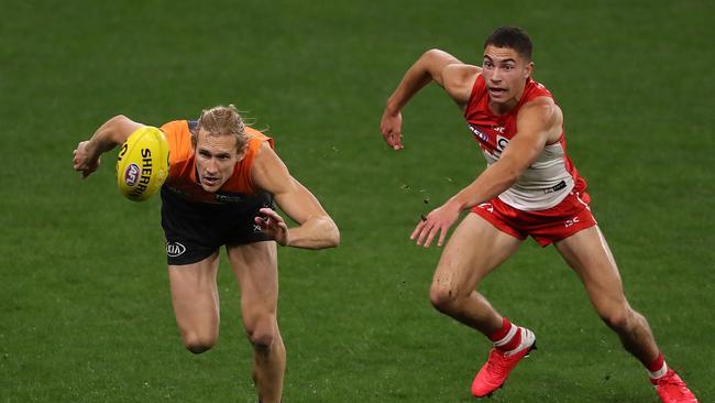 Giant Nick Haynes and Swan Zac Foot compete for the footy on Thursday night. Picture: Paul Kane/Getty Images