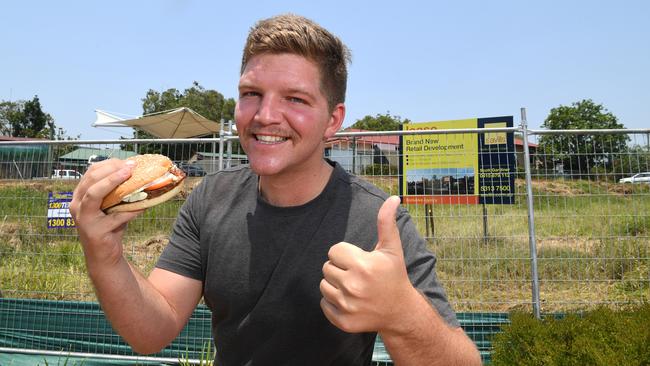 WHOPPER: Construction of Hungry Jack’s will soon start in Nambour. Joe Cashman is pictured on site with a Hungry Jacks burger. Photo: Warren Lynam