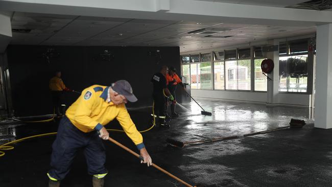 The Camden sports club and Bowling club flooded again after most repairs from the last flood were being completed. RFS members help locals clean up.