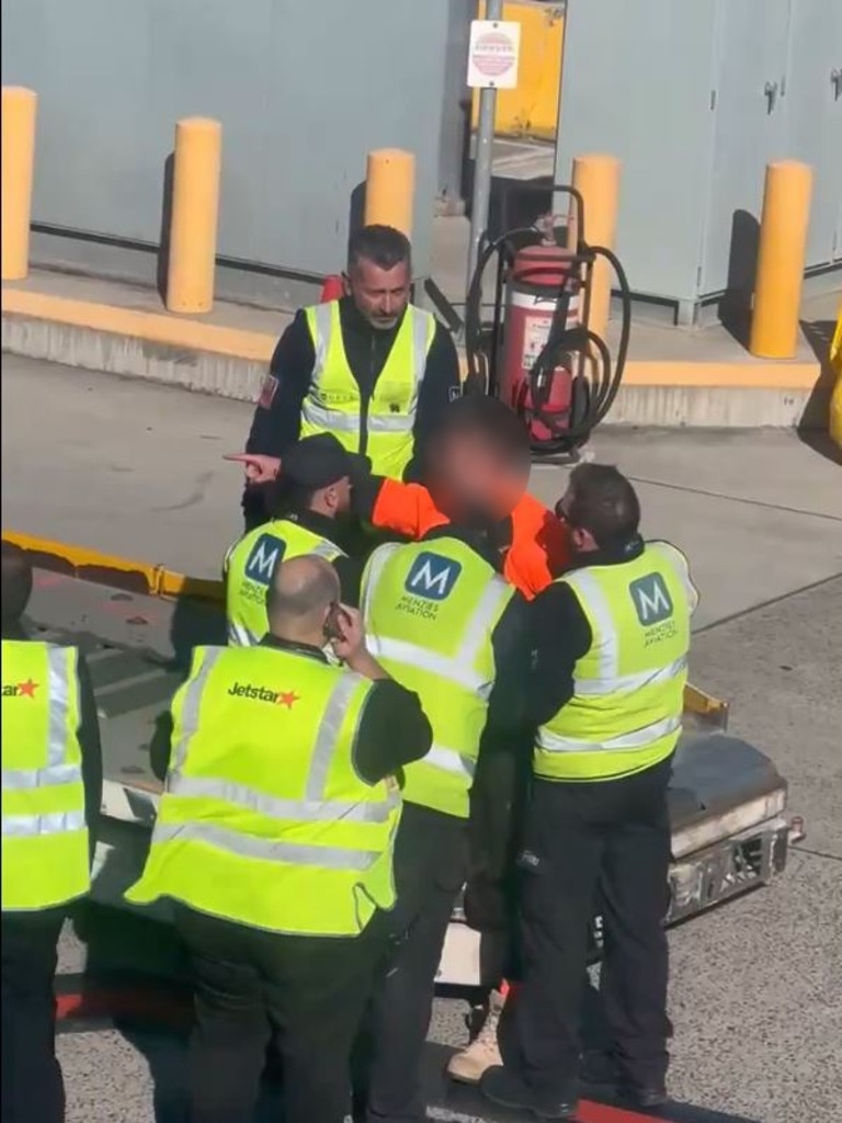 Ground handlers surrounded the man on the ground. Picture: X