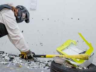 April Hard  destroying a printer at Smash Pit in Southport. Picture: Jerad Williams