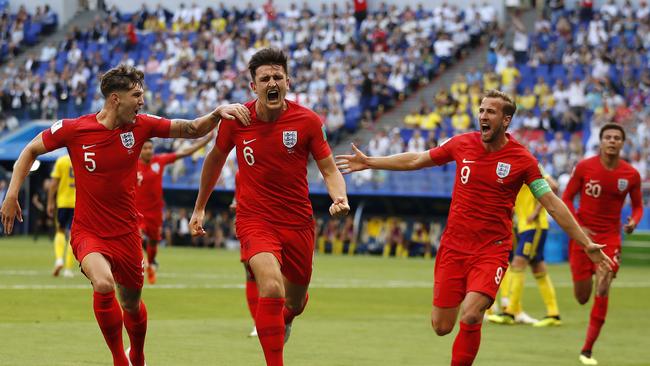 England's Harry Maguire, center, celebrates with his teammates after scoring his side opening goal during the quarterfinal match between Sweden and England at the 2018 soccer World Cup in the Samara Arena, in Samara, Russia, Saturday, July 7, 2018. (AP Photo/Francisco Seco)