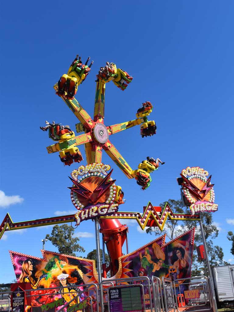 Thrill seekers at the Fraser Coast Ag Show fly through the air on the Power Surge ride. Photo: Stuart Fast