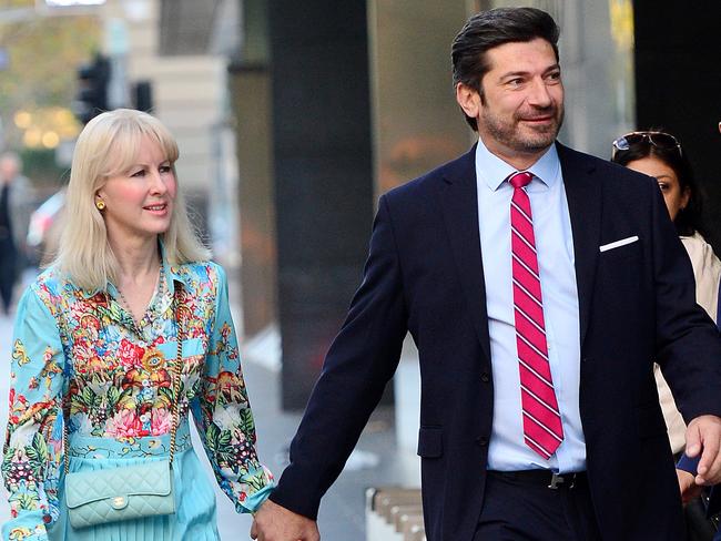 A smiling Constantine Arvanitis arrives at the County Court of Victoria with his fiancee, Melanie Thornton. Picture: Nicki Connolly