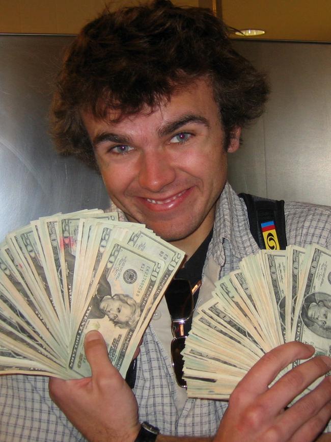 A grinning Luke Carroll poses with some of the stolen money.