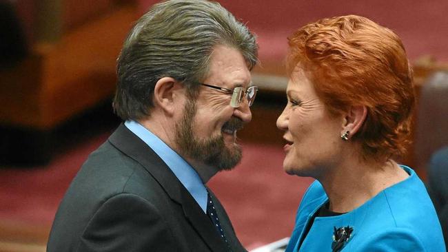 Justice Party Senator Derry Hinch congratulates One Nation leader Senator Pauline Hanson after making her maiden speech in the Senate in Canberra. Picture: MICK TSIKAS