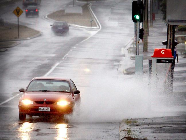 Cars driving on wet rain soaked Montague Road, Modbury 20 Mar 2007. weather traffic