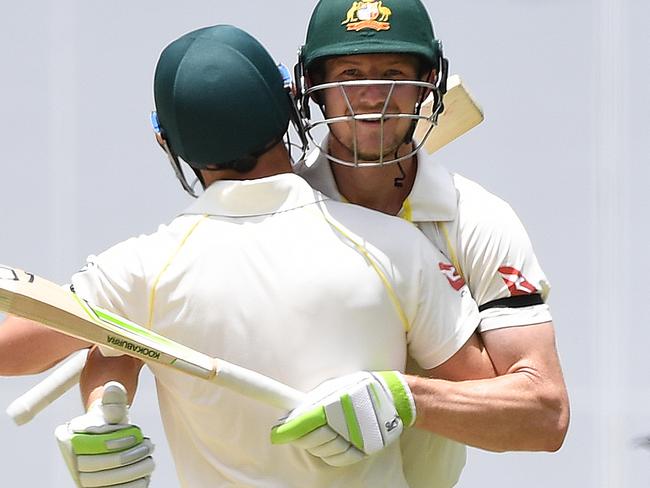Australian batsmen David Warner (left) and Cameron Bancroft celebrate after Australia won on Day 5 of the First Test match between Australia and England at the Gabba in Brisbane, Monday, November 27, 2017. (AAP Image/Dave Hunt) NO ARCHIVING, EDITORIAL USE ONLY, IMAGES TO BE USED FOR NEWS REPORTING PURPOSES ONLY, NO COMMERCIAL USE WHATSOEVER, NO USE IN BOOKS WITHOUT PRIOR WRITTEN CONSENT FROM AAP