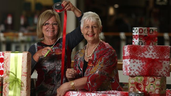 Volunteers Suzanne Gulley and Jan James wrap gifts this Christmas. Picture: Brendan Francis