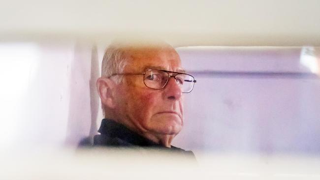 Roger Rogerson inside a police truck being taken into Bankstown Court to face charges relating to the murder of Jamie Gao. Picture: Craig Greenhill