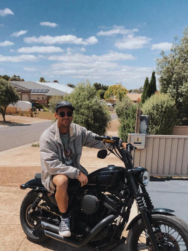 Farha on his black Harley Davidson motorcycle.