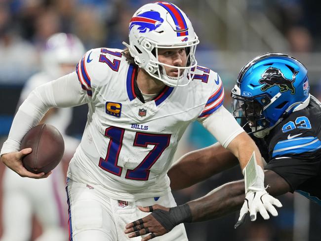 DETROIT, MICHIGAN - DECEMBER 15: Josh Allen #17 of the Buffalo Bills runs with the ball while being chased by Josh Paschal #93 of the Detroit Lions in the third quarter at Ford Field on December 15, 2024 in Detroit, Michigan. (Photo by Nic Antaya/Getty Images)