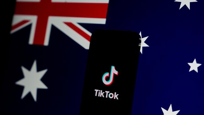 MELBOURNE, AUSTRALIA - NOVEMBER 30: In this photo illustration, the TikTok app is open on a phone with the Australian flag displayed in the background on November 30, 2024 in Melbourne, Australia. Australia has recently enacted a groundbreaking law prohibiting individuals under the age of 16 from accessing social media platforms, marking one of the strictest regulations of its kind globally. This legislation, which holds social media companies accountable for enforcing the ban with potential fines of up to AUD 50 million, aims to protect young users from online dangers such as bullying and exploitation, reflecting a significant shift in how governments address youth safety in the digital age. (Photo Illustration by Asanka Ratnayake/Getty Images)