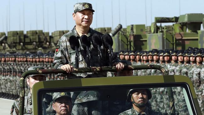 Chinese President Xi Jinping stands on a military jeep as he inspects troops of the People's Liberation Army. Picture: AP