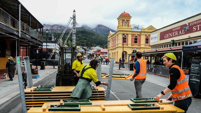 Festival staff packing up in Queenstown's main St as the Unconformity Festival was cancelled. Picture: Chris Crerar