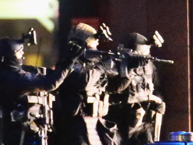 SYDNEY, AUSTRALIA - DECEMBER 15: Armed police take aim outside the Lindt Cafe, Martin Place on December 15, 2014 in Sydney, Australia. Police attend a hostage situation at Lindt Cafe in Martin Place. (Photo by Don Arnold/Getty Images)