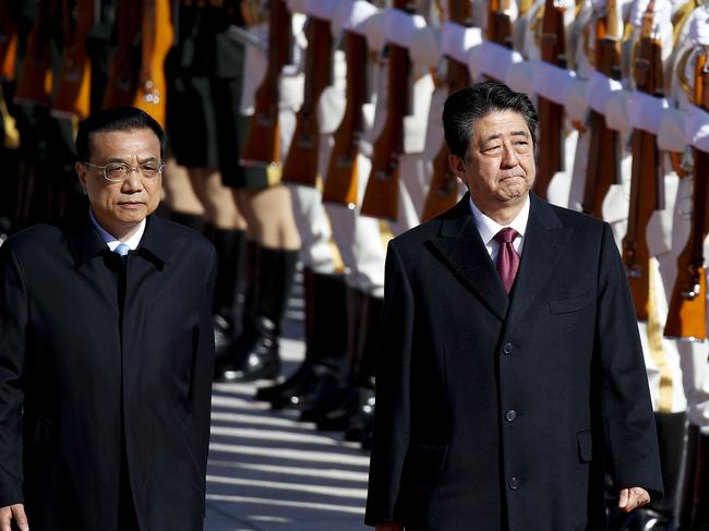 Japanese Prime Minister Shinzo Abe, right, and Chinese Premier Li Keqiang review an honor guard during a welcome ceremony at the Great Hall of the People in Beijing, Friday, Oct. 26, 2018. (AP Photo/Andy Wong)