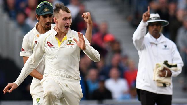 Umpire Kumar Dharmasena indicates 'out' as Australia's Marnus Labuschagne (2nd L) celebrates after taking the wicket of England's Jack Leach.