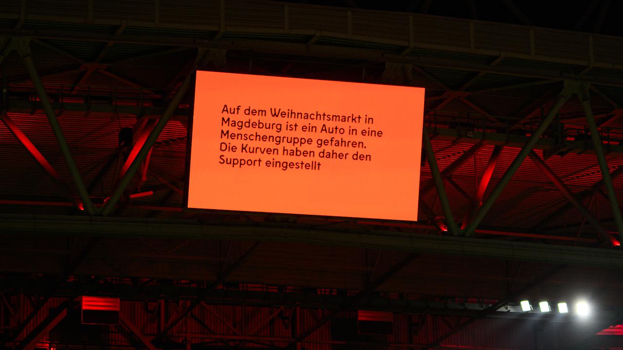 The video wall in the stadium shows the latest news on the events in Magdeburg. Picture: Frederic Scheidemann/Getty