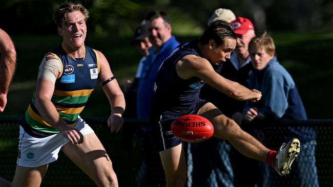 VAFA: Old Melburnians’ Benjamin Harding gets a kick away under pressure. Picture: Andy Brownbill