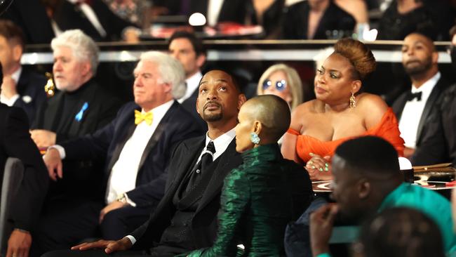 Will and Jada at the Oscars, with actor Aunjanue Ellis (in orange) seated behind them to Will’s right. Picture: Robert Gauthier / Los Angeles Times via Getty