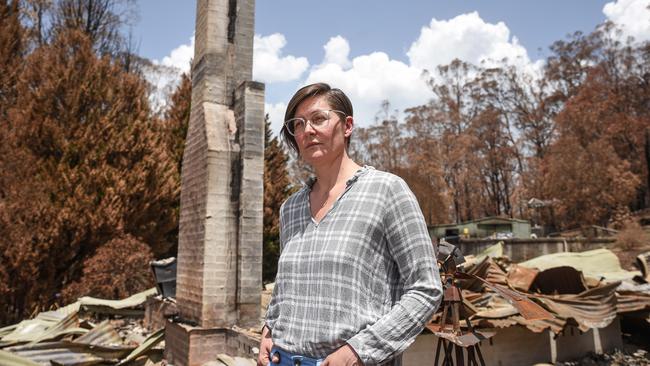 Sarah Haslinger stands in front of the remains of her house which burned down in Sutton Forest Inn, Illawarra. Picture: Flavio Brancaleone