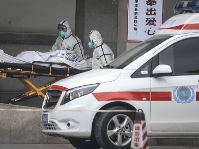 Medical staff transfer patients to Jin Yintan hospital in Wuhan. Picture: Getty Images