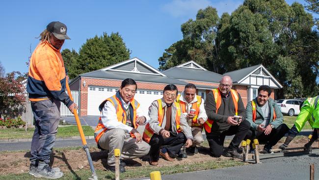 Rajeev Roychand, third from right, with council officers and the RMIT research team at the pour of coffee concrete for a footpath trial in Gisborne