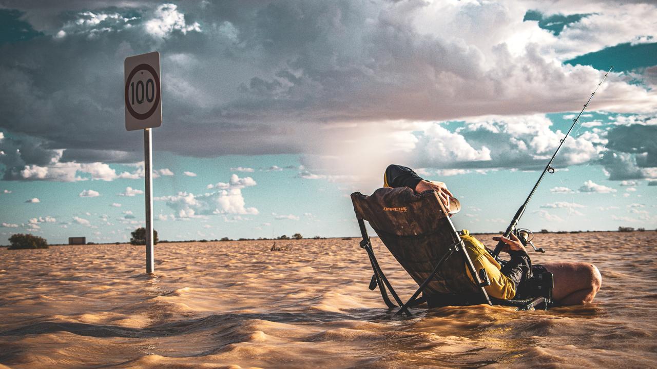 Flood waters from Tropical Cyclone Kirrily have reached Birdsville with those in the area having some fun in photos - Liam Brooker throwing a line out and hoping. Picture: Peta Rowlands Wangkangurru/Yarluyandi Traditional Owner of Birdsville