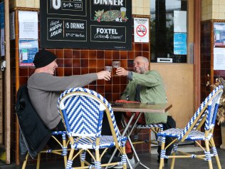 Two men enjoying a beer at the Bells Pub in Woolloomooloo wharf as restaurants reopen in Sydney on "Freedom Day". in Sydney. Picture:  NCA NewsWire / Gaye Gerard