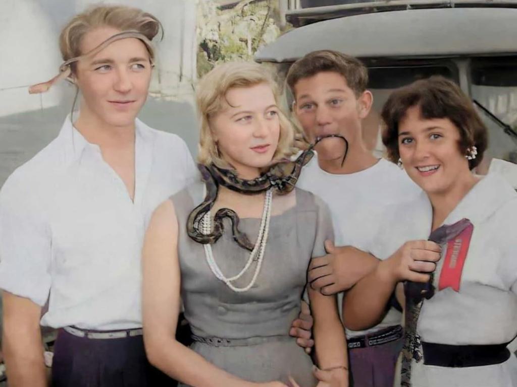 Draped in snakes Marcia Izod and friends Jim, Ted, and Lyn Dennis enjoy the Darwin Show in 1958. Source: the Izod collection, Library & Archives NT and Darwin Colourising Yesteryear FB site.