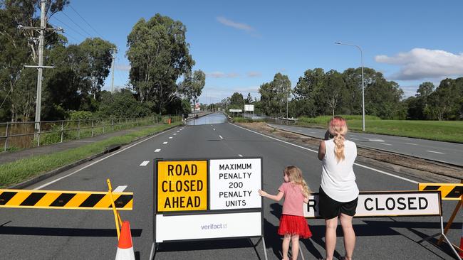 Spectators at the Larry Storey Bridge at Waterford West, where penalties apply for driving past the road closed sign. Picture: NIGEL HALLETT