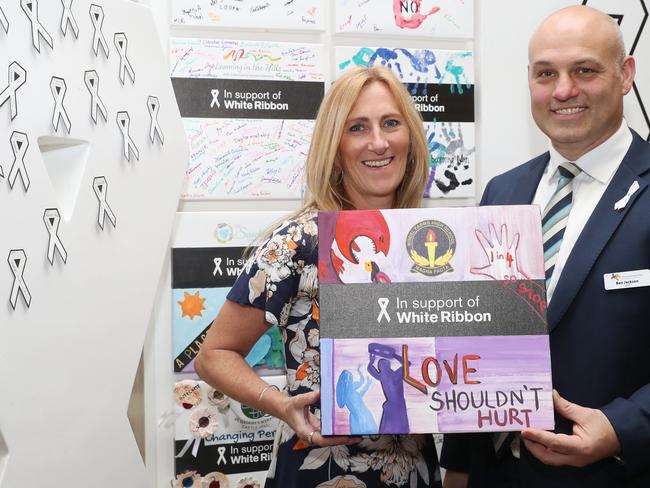 Hills Community Aid CEO Ben Jackson and Kellie Lumley, Head of Welfare at Model Farms High, with an art work from the school at Castle Towers. Picture: David Swift