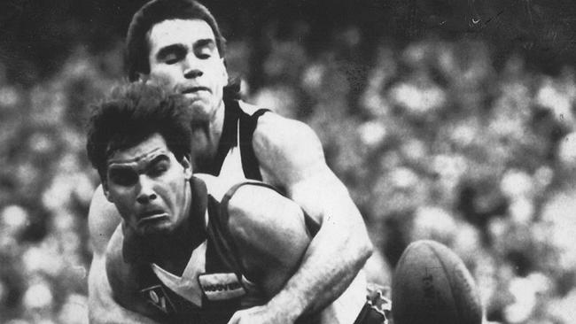 Greg Phillips tackles Greg Williams while playing for Collingwood.