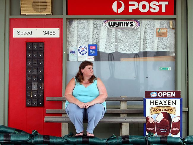 <p>Owner Anita Kataja sits out front of the Speed Post office with sandbags.</p> <p>Picture: Ben Swinnerton</p>