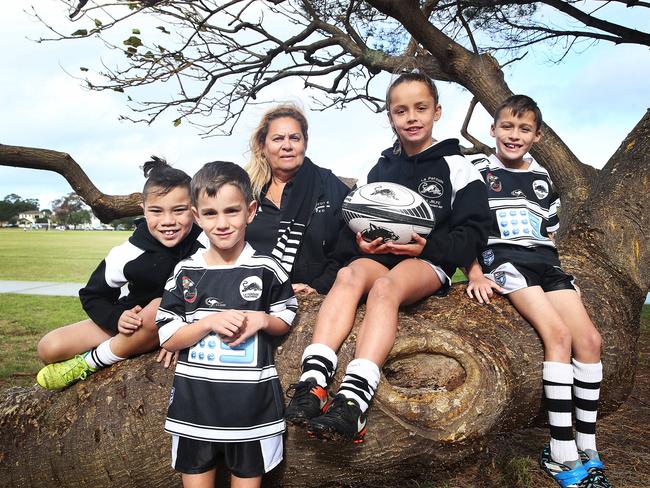 Sherri Longbottom and  Under 8's La Perouse Rugby League Players (from left)  Tallis Danks, Cadel Walters, Code Ryan Last, Cadel Walters and Robert Stanley pose for a photo on the 3nd of June, 2018 at Rowland Park. Sherri Longbottom is a volunteer with La Perouse Rugby League Club.  (AAP IMAGE/ Danny Aarons)