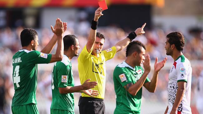 Iraqi players applaud as Referee Ben Williams sends Mehrdad Pooladi off.