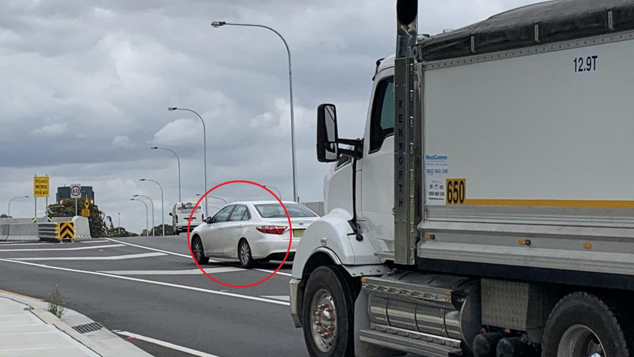 A car dangerously swerving through chevrons on Wattle St, Haberfield, in the way of a truck close to the M4 WestConnex motorway. Picture: Benedict Brook